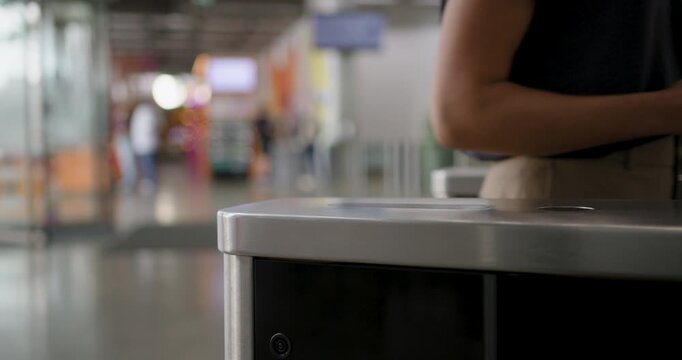 Businesswoman using Phone to access Office, opening turnstile with smart phone