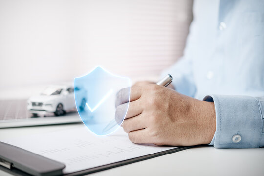 Business professional reviewing an insurance policy with a glowing shield and check mark overlay, representing financial protection, risk management, secure coverage, compliance, and peace of mind