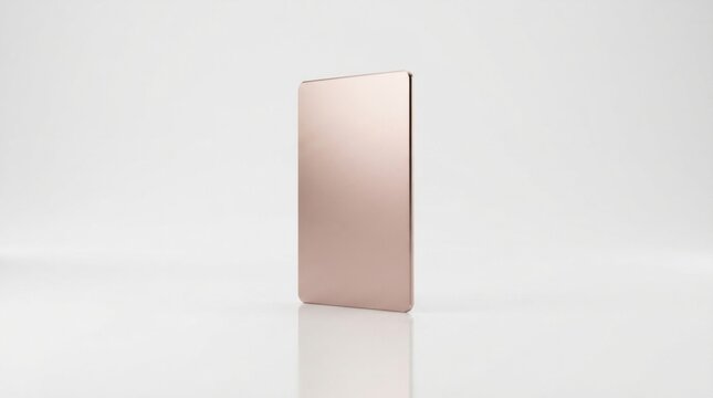 A single blank rose gold metal card standing upright on a clean light surface