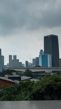 Vertical video - Timelapse of Jakarta ckylines on a cloudy day