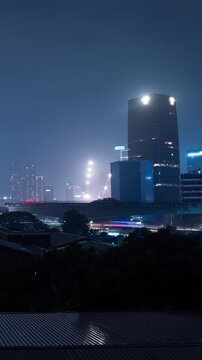 Vertical video - Timelapse of Jakarta central business district on a rainy night
