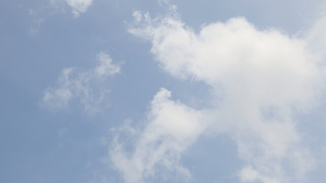 A clouds scattered across a light blue sky