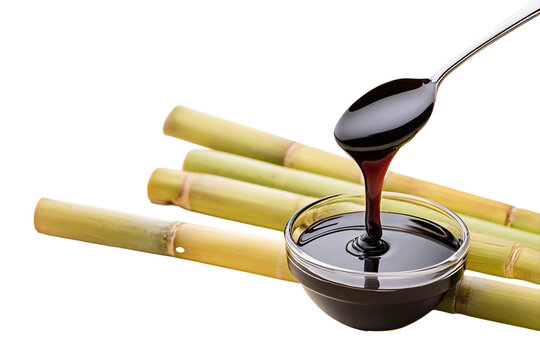 Thick black molasses dripping from a spoon above a glass bowl with bamboo stalks isolated on transparent background png element