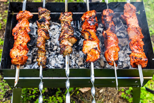 colorful shish kebabs on steel skewers on mangal