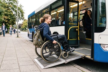 Obraz premium A teenager in a wheelchair is rolling up a ramp to enter a public bus. The scene shows city life with people walking nearby and trees lining the street on a clear day