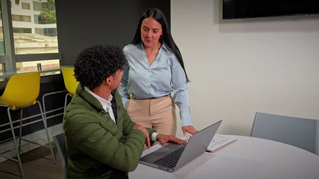 Professional Mentor Guiding A Young Colleague During A Work Session
