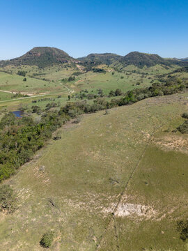 Aerial view of hills in Brazilian countryside under a blue sky