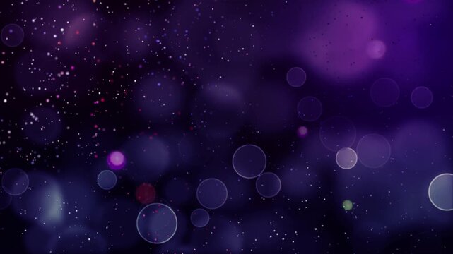 Purple bokeh effect displays glowing circles and sparkling dust particles scattered across a deep violet atmosphere.