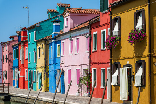 The brightly painted, multi-colored houses along a canal on the island of Burano