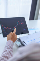Businessman working on screen monitoring stock market to analyze data and investment portfolio...