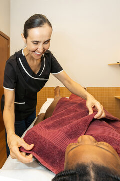 Therapist preparing client for a relaxing wellness treatment