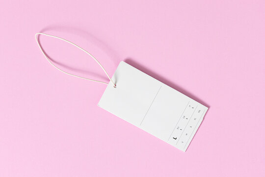 blank white clothing price tag mock up on pink background