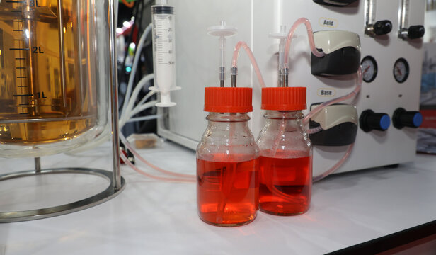 Laboratory bioreactor system with acid and base reagent bottles