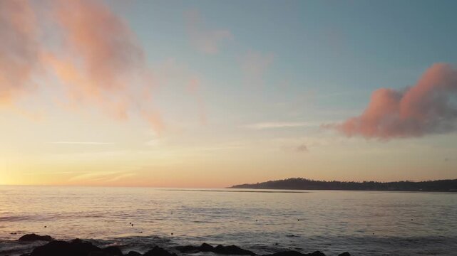 timelapse of a sunset over ocean with mountains
