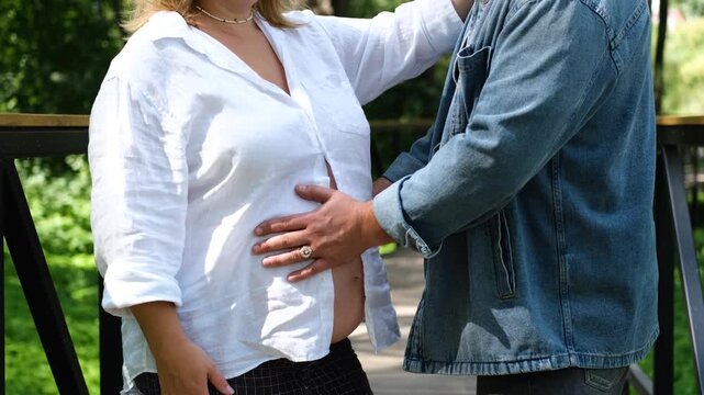 Partner Touching Pregnant Belly Outdoors, Expectant Parents, Pregnancy Support, Family Connection and Father Bonding with Baby
