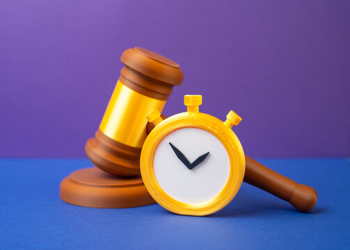 Judge's gavel and a clock. Concept of time pressure in legal proceedings. Symbol of justice, deadlines, court order and the urgency of legal decisions and trial deadlines.