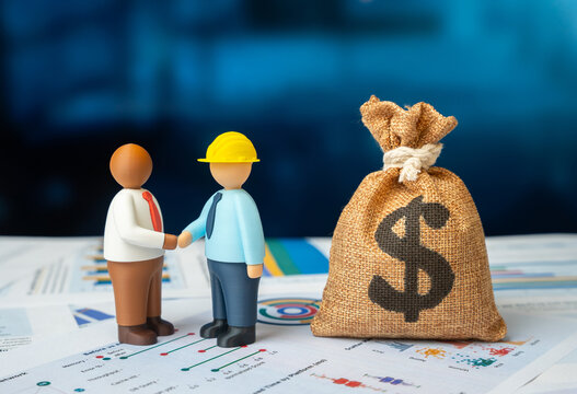 A businessman and an engineer agreeing on project implementation, and a bag of dollar money. Concept of investment and partnership. Symbol of successful business cooperation.