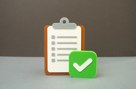 A paper tablet and an approval checkmark. Passing a test, meeting the requirements. Concept of certification and success. Symbol of qualification and achieved standards.