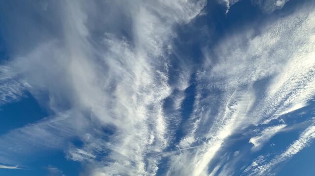 A very beautiful, inspiring blue sky with white, feathery clouds.