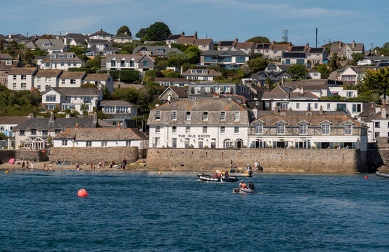 St Mawes Cornwall England UK. 13.08.2026. A picturesque seaside town with traditional architecture slopes down to a sandy beach and clear blue water with small boats sailing