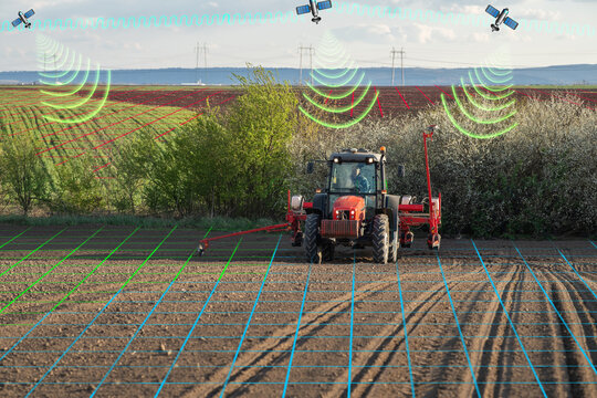 Modern tractor planting corn with precision seeder on agricultural field