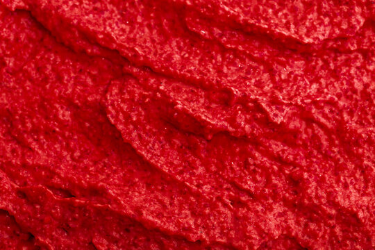 Red berry yogurt ice cream. Fresh fruit smoothie with strawberries, raspberries, pomegranate and red currants. Ice cream texture. Delicious sweet dessert close-up as a background.