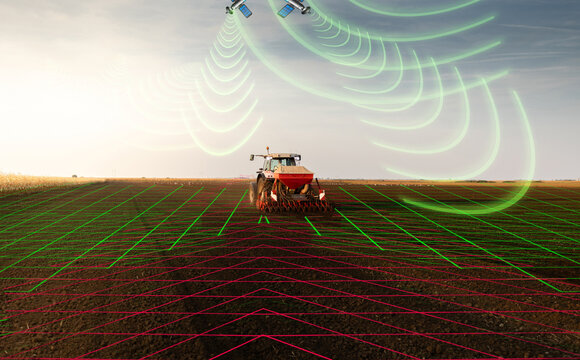 Modern tractor planting corn with precision seeder on agricultural field