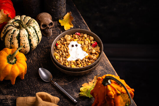 Halloween spooky breakfast with granola and yogurt in shape of ghost