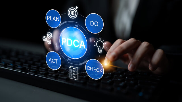 Business professional engaging with PDCA cycle concepts while focusing on keyboard for project management and continuous improvement strategy in office setting. Bitwise.