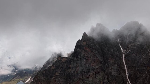 Aerial view of rugged mountain peaks in clouds