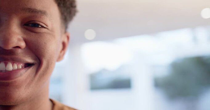 Adult African descent male smiling and widening grin from offscreen prompt by home window