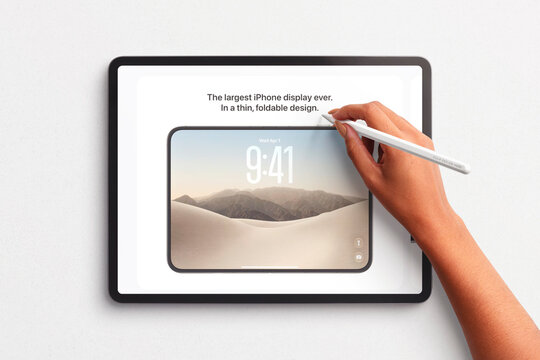 Hand using stylus on large foldable phone display concept