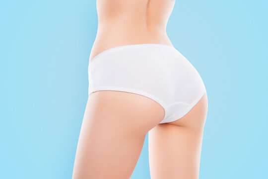 Close up photo of fit woman's ass with perfect ideal skin in white lingerie isolated over white background result of anti cellulite cream scrub. Wellness wellbeing spa salon concept