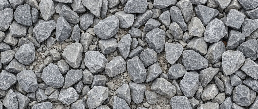 Gray crushed gravel stone texture. Overhead view of natural rock driveway surface