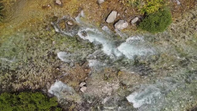 Rugged terrain flows with a clear, rushing stream (Munzur Gozeleri Ovacik Tunceli)