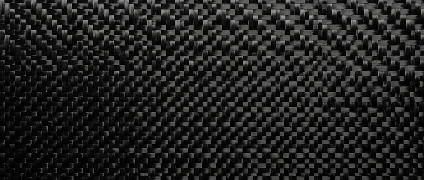 Black carbon fiber weave texture background. Glossy composite material pattern