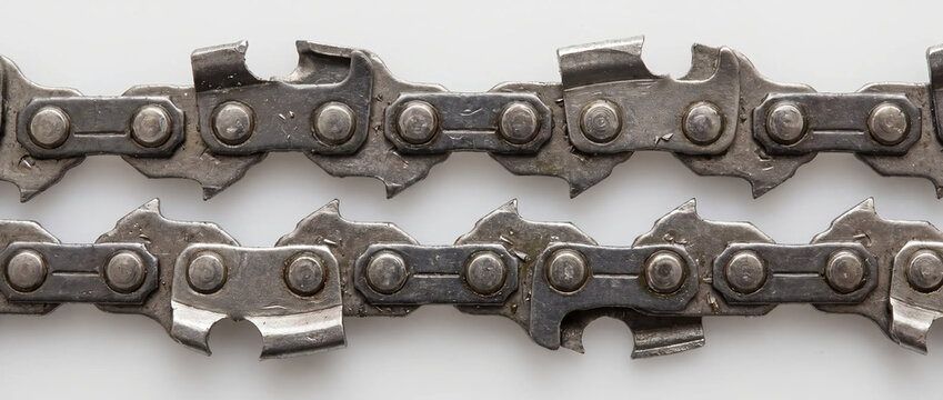 Chainsaw chain blade close up. Sharp steel saw teeth on white background