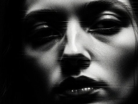 Abstract black, white close up of human face with digital glitch effect. Horizontal lines distort facial features creating mysterious monochrome texture. Surreal pixelated pattern shows fragmented