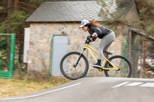 Woman ride bicycle on outdoor pump track
