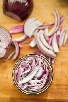 Sliced red onion prepared for homemade pickling recipe