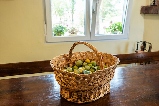 Basket of fresh green fruit on rustic wooden table