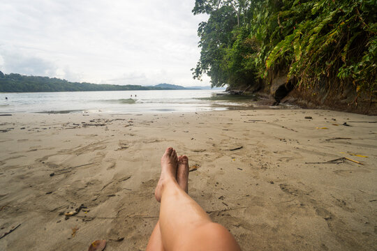 Bare feet on tropical beach in Costa Rica
