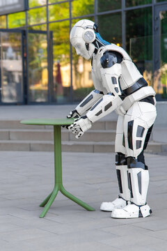 Robotic assistant setting up green bistro table