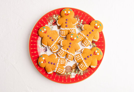 Christmas gingerbread cookies on festive red holiday plate