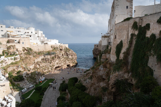 high angle view of the famous lama monachile beach, cala porto. in the historic center of polignano a mare, apulia, southern italy.