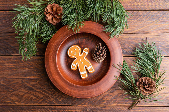 Christmas gingerbread man cookie on rustic wooden table
