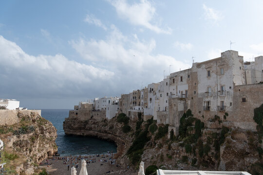 high angle view of the famous lama monachile beach, cala porto. in the historic center of polignano a mare, apulia, southern italy.