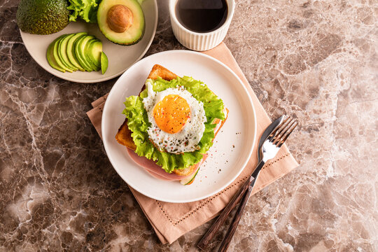 Avocado, sandwich with lettuce ham and cucumber slices