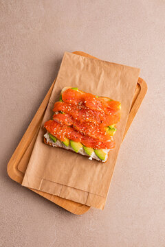 Salmon avocado open sandwich in paper bag