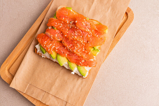 Salmon avocado cream cheese canape with sesame seeds